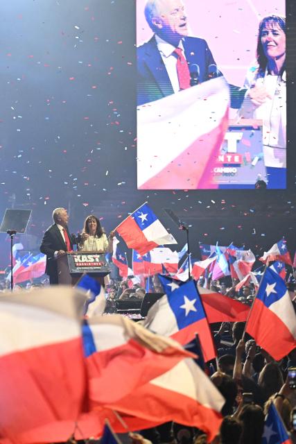 Chile's presidential candidate Jose Antonio Kast of the Republican Party speaks next to his wife Maria Pia Adriasola during his closing campaign rally at Movistar Arena in Santiago on November 11, 2025. Chile will hold the presidential election on November 16, 2025. (Photo by Marvin RECINOS / AFP)