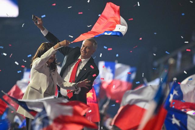 Chile's presidential candidate Jose Antonio Kast of the Republican Party takes a picture with his cellphone next to his wife Maria Pia Adriasola during his closing campaign rally at Movistar Arena in Santiago on November 11, 2025. Chile will hold the presidential election on November 16, 2025. (Photo by MARVIN RECINOS / AFP)