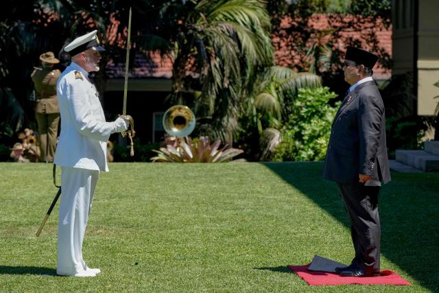 Indonesia's President Prabowo Subianto (R) receives a salute at Admiralty House in Sydney on November 12, 2025. (Photo by Rick Rycroft / POOL / AFP)