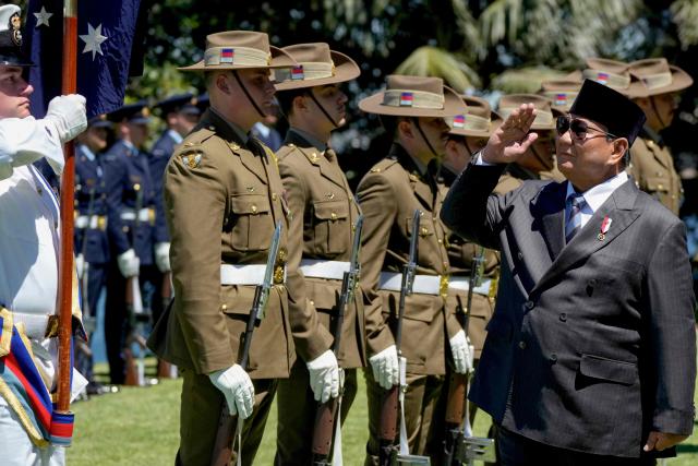 Indonesia's President Prabowo Subianto (R) inspects a guard of honour at Admiralty House in Sydney on November 12, 2025. (Photo by Rick Rycroft / POOL / AFP)