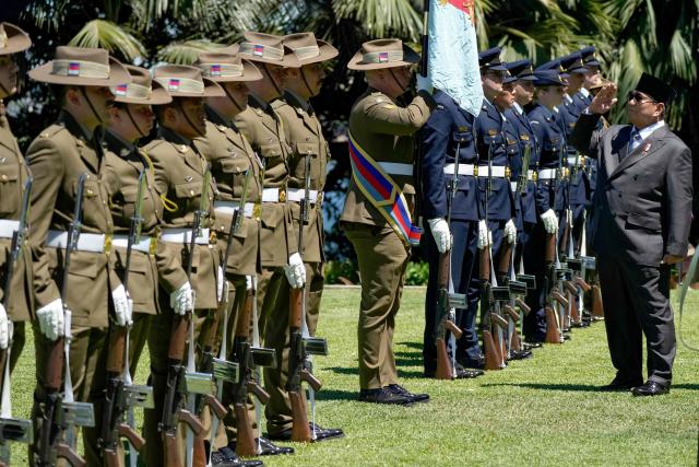 Indonesia's President Prabowo Subianto (R) inspects a guard of honour at Admiralty House in Sydney on November 12, 2025. (Photo by Rick Rycroft / POOL / AFP)