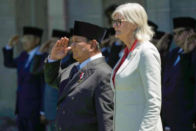 Indonesia's President Prabowo Subianto (L) inspects a guard of honour with Australia's Governor General Sam Mostyn at Admiralty House in Sydney on November 12, 2025. (Photo by Rick Rycroft / POOL / AFP)