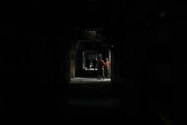 People walk at a closed market near the blast site, after an explosion in the Red Fort area in the old quarters of Delhi, on November 12, 2025. Indian Prime Minister Narendra Modi on November 11 called a deadly car explosion in the heart of the capital a "conspiracy", vowing those responsible will face justice. (Photo by Arun SANKAR / AFP)
