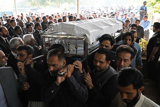 Mourners carry the coffin of a lawyer during his funeral in Islamabad on November 12, 2025, a day after suicide bombing. Charred vehicles and a mangled motorcycle lay outside Islamabad's district court on November 11, their metal frames still warm as investigators sealed off the area where a suicide bomber had killed at least 12 people. (Photo by Aamir QURESHI / AFP)