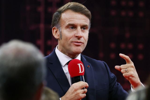 France's President Emmanuel Macron speaks to readers of the newspaper "La Dépêche du Midi" before inaugurating the French Space Command in Toulouse on November 12, 2025. (Photo by Guillaume HORCAJUELO / POOL / AFP)