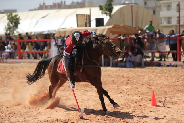 Spectators watch as an athlete participates in a tent-pegging equestrian competition in Yemen's Huthi-controlled capital, Sanaa, on November 12, 2025. (Photo by Mohammed HUWAIS / AFP)