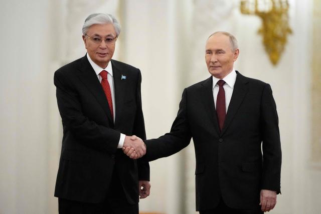 Russia's President Vladimir Putin and Kazakhstan's President Kassym-Jomart Tokayev shake hands during their meeting at the St. George's Hall of the Grand Kremlin Palace in Moscow on November 12, 2025. (Photo by Alexander Zemlianichenko / POOL / AFP)