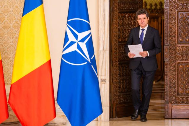 Romanian President Nicusor Dan arrives to address the media in a press conference at the presidential Cotroceni Palace in Bucharest, Romania, to present the country's new national defence strategy, on November 12, 2025. (Photo by Mihai BARBU / AFP)
