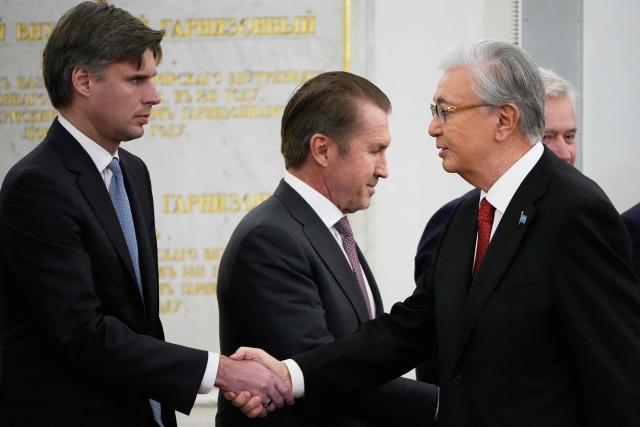 Kazakhstan's President Kassym-Jomart Tokayev shakes hands with Roscosmos State Space Corporation Director General Dmitry Bakanov during his meeting with Russia's President at the St. George's Hall of the Grand Kremlin Palace in Moscow on November 12, 2025. (Photo by Alexander Zemlianichenko / POOL / AFP)