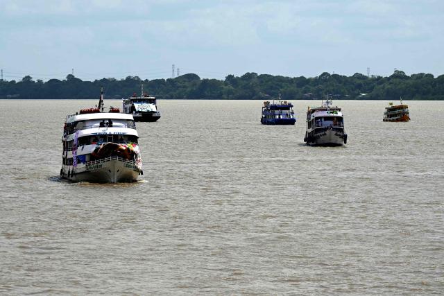 View of a boat trip of indigenous people and social organizations in the sidelines of the COP30 UN Climate Change Conference in Belem, Para State, Brazil, on November 12, 2025. Over 150 boats with members of indigenous communities and social organizations will sail the Guama River as part of a symbolic crossing during the COP30, according to organizers. (Photo by Pablo PORCIUNCULA / AFP)