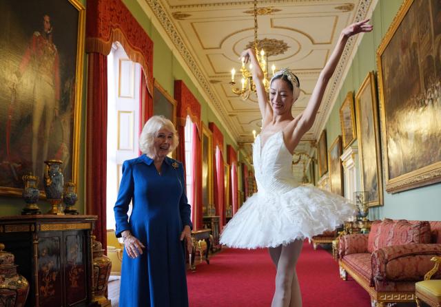 Queen Camilla, reacts as she watches South Korean ballerina Sangeun Lee, during a reception to celebrate the English National Ballet's 75th anniversary, at Buckingham Palace in central London on November 12, 2025. (Photo by Yui Mok / POOL / AFP)