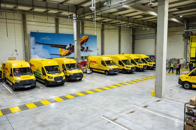 This photograph shows DHL delivery electric vehicles parked at a DHL warehouse in Lesquin, near Lille, on November 12, 2025. (Photo by Sameer Al-DOUMY / AFP)