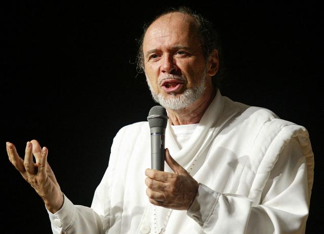 (FILES) Former French journalist known as cult leader "Rael", founder of the "Raelian Revolution", Claude Vorilhon gestures as he delivers a speech at a conference in Tokyo, on August 4, 2002. A complaint was filed on November 12, 2025 for sexual abuse and torture of a minor against Claude Vorilhon, alias Rael, and two other members of the sect he founded, announced lawyer Aline Lebret, who represents a former Raelian follower who was "under psychological control". (Photo by TOSHIFUMI KITAMURA / AFP)