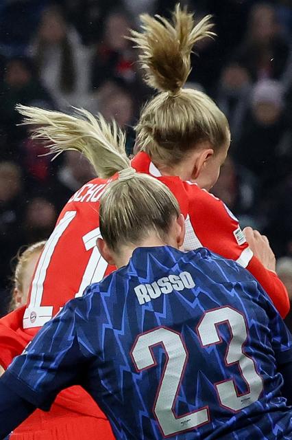 Arsenal's English forward #23 Alessia Russo and Bayern Munich's German forward #11 Lea Schueller both jump to head the ball during the UEFA Women's Champions League football match FC Bayern Munich vs Arsenal in Munich, southern Germany on November 12, 2025. (Photo by Karl-Josef HILDENBRAND / APA / AFP) / ALTERNATIVE CROP