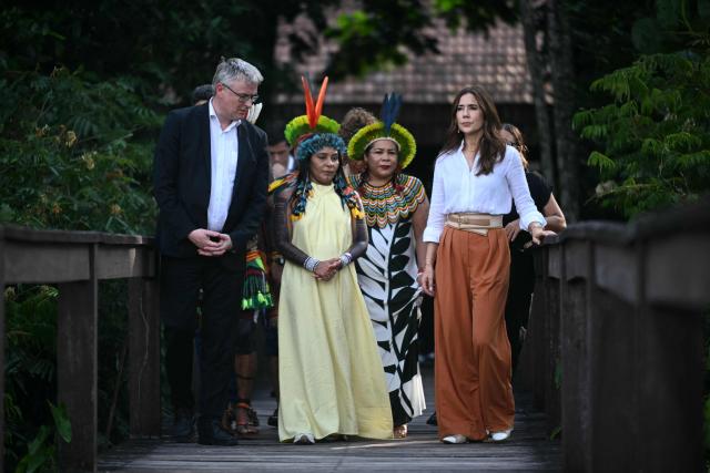 Denmark's Queen Mary (R) walks with local Indigenous leaders during her visit at Utinga Park in the sidelines of the COP30 UN Climate Change Conference in Belem, Para State, Brazil on November 12, 2025. (Photo by Mauro PIMENTEL / AFP)