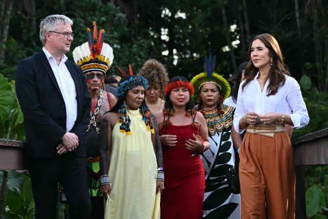 Denmark's Queen Mary (R) and Denmark's Minister of Food, Agriculture and Fisheries, Jacob Jansen (L) speak with local Indigenous leaders during their visit to Utinga Park in the sidelines of the COP30 UN Climate Change Conference in Belem, Para State, Brazil on November 12, 2025. (Photo by Mauro PIMENTEL / AFP)