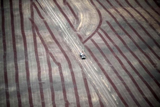This aerial view shows a truck passing by a deforested area of the Amazon rainforest prepared for plantation in the surroundings of Belem, Para State, Brazil, on November 12, 2025, during the COP30 UN Climate Change Conference. (Photo by Mauro PIMENTEL / AFP)