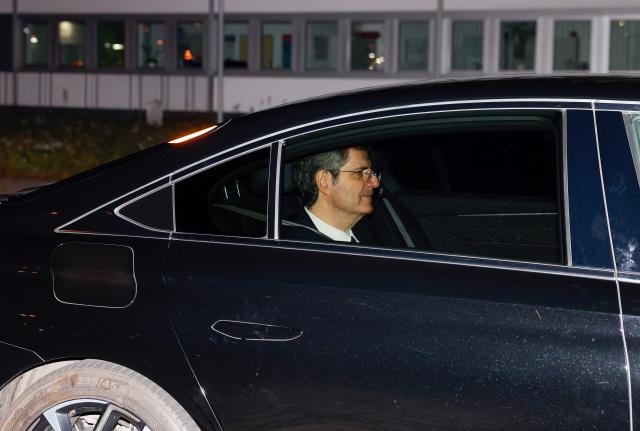 Ambassador of France to Germany Francois Delattre is seen in a car, part of a convoy believed to be transporting Franco-Algerian writer Boualem Sansal as they leave Berlin's Schoenefeld airport on November 12, 2025 after Algeria has accepted a request by Germany's President to free the 81-year-old for medical treatment after a year in detention. Sansal was given a five-year jail term in March 2025, accused of undermining Algeria's territorial integrity after he told a far-right French outlet last year that France had unjustly transferred Moroccan territory to Algeria during the 1830 to 1962 colonial period. (Photo by Odd ANDERSEN / AFP)