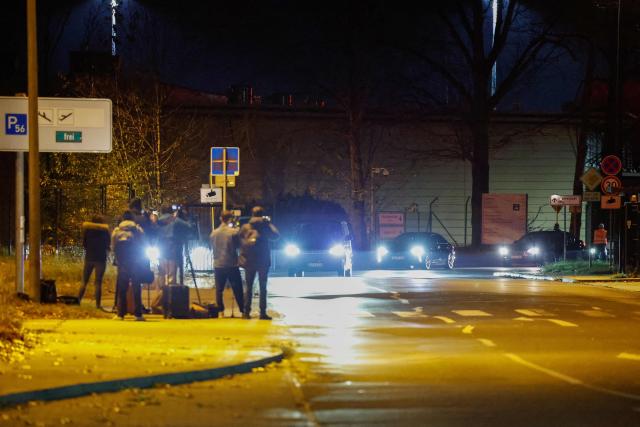 Members of the media film a convoy believed to be transporting Franco-Algerian writer Boualem Sansal as they leave Berlin's Schoenefeld airport on November 12, 2025 after Algeria has accepted a request by Germany's President to free the 81-year-old for medical treatment after a year in detention. Sansal was given a five-year jail term in March 2025, accused of undermining Algeria's territorial integrity after he told a far-right French outlet last year that France had unjustly transferred Moroccan territory to Algeria during the 1830 to 1962 colonial period. (Photo by Odd ANDERSEN / AFP)