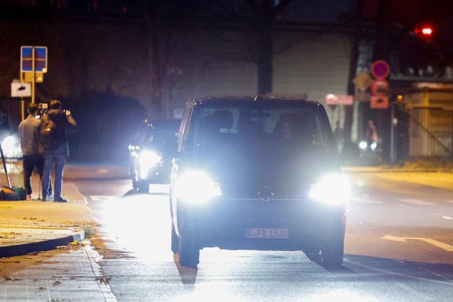 Members of the media film a convoy believed to be transporting Franco-Algerian writer Boualem Sansal as they leave Berlin's Schoenefeld airport on November 12, 2025 after Algeria has accepted a request by Germany's President to free the 81-year-old for medical treatment after a year in detention. Sansal was given a five-year jail term in March 2025, accused of undermining Algeria's territorial integrity after he told a far-right French outlet last year that France had unjustly transferred Moroccan territory to Algeria during the 1830 to 1962 colonial period. (Photo by Odd ANDERSEN / AFP)