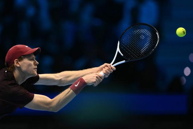 Italy's Jannik Sinner hits the ball during his match against Germany's Alexander Zverev at the ATP Finals tennis tournament in Turin on November 12, 2025. (Photo by Marco BERTORELLO / AFP)
