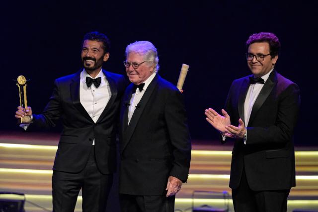 Egyptian actor Khaled al-Nabawy (L) receives a honour award from Egyptian Minister of Culture Ahmed Fouad Hano (R) and president of the Cairo International Film Festival Hussein Fahmi (C) during the opening ceremony of the 46th Cairo International Film Festival (CIFF) in Cairo on November 12, 2025. (Photo by Khaled DESOUKI / AFP)