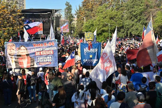 Supporters of Chile's presidential candidate Johannes Kaiser of the Libertarian National Party attend his closing campaign rally in Santiago on November 12, 2025. (Photo by Victor RUIZ / AFP)