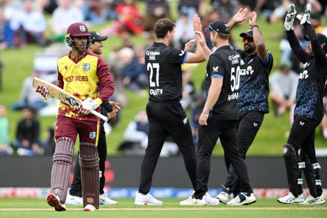 West Indies' Ackeem Auguste (L) walks back to the pavilion after his dismissal during the fifth and final Twenty20 international cricket match between New Zealand and West Indies at University of Otago Oval in Dunedin on November 13, 2025. (Photo by Sanka VIDANAGAMA / AFP)