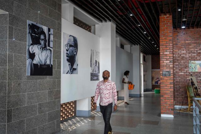 A visitor walks through the corridor of the National Museum during the exhibition ‘Mobutu, a life, a destiny’ in Kinshasa, capital of the Democratic Republic of Congo, on 17 October 2025. Almost thirty years after the fall of Mobutu Sese Seko, an exhibition dedicated to the former president of Zaire (now the Democratic Republic of Congo, DRC) is generating keen interest among young Congolese born after 1997. Entitled ‘Mobutu, a life, a destiny’, the exhibition, organised by the family of the former president of the Republic, presents personal items, photographs and other archival documents. (Photo by Glody MURHABAZI / AFP)