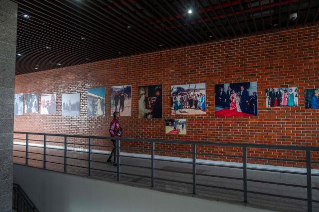 A visitor looks at photos from the exhibition ‘Mobutu, a life, a destiny’ at the National Museum in Kinshasa, on October 17, 2025. Almost thirty years after the fall of Mobutu Sese Seko, an exhibition dedicated to the former president of Zaire (now the Democratic Republic of Congo, DRC) is generating keen interest among young Congolese born after 1997. Entitled ‘Mobutu, a life, a destiny’, the exhibition, organised by the family of the former president of the Republic, presents personal items, photographs and other archival documents. (Photo by Glody MURHABAZI / AFP)
