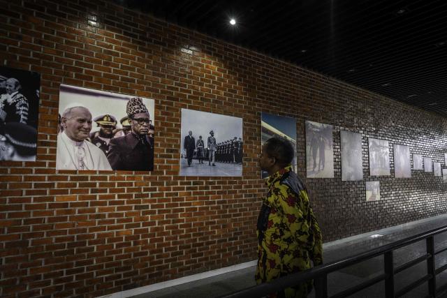 A visitor looks at photos from the exhibition ‘Mobutu, a life, a destiny’ at the National Museum in Kinshasa, on October 17, 2025. Almost thirty years after the fall of Mobutu Sese Seko, an exhibition dedicated to the former president of Zaire (now the Democratic Republic of Congo, DRC) is generating keen interest among young Congolese born after 1997. Entitled ‘Mobutu, a life, a destiny’, the exhibition, organised by the family of the former president of the Republic, presents personal items, photographs and other archival documents. (Photo by Glody MURHABAZI / AFP)