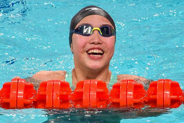 China's Yu Zidi celebrates winning the women's 200 metre individual medley during the National Games of China in Shenzhen on November 11, 2025. Chinese swimming prodigy Yu Zidi sent shockwaves through the swimming world again with a blistering Asian record time at China's National Games in Shenzhen. Yu, who turned 13 in October, swam an impressive 2:07:41 to claim gold in the women's 200 metre individual medley on November 11. (Photo by AFP) / China OUT