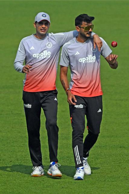 India’s captain Shubman Gill (L) and teammate Axar Patel interact during a practice session on the eve of their first Test cricket match against South Africa, at the Eden Gardens in Kolkata on November 13, 2025. (Photo by DIBYANGSHU SARKAR / AFP)