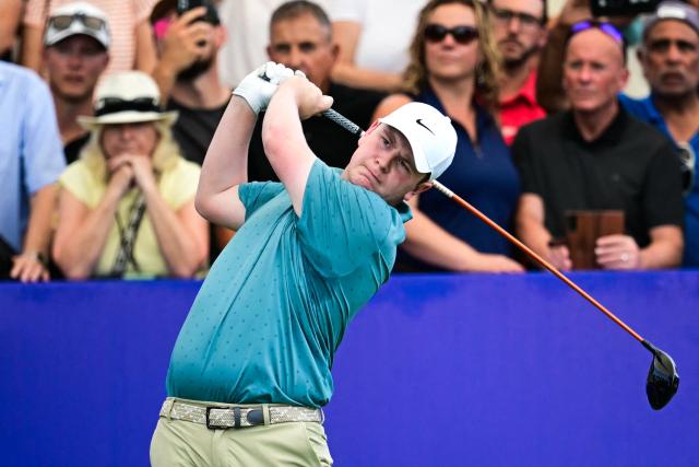 Scotland's Robert MacIntyre tees off at the first hole on day one of the DP World Tour Championship 2025 golf tournament at Jumeirah Golf Estates in Dubai on November 13, 2025. (Photo by Giuseppe CACACE / AFP)