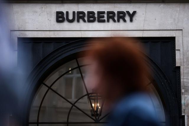 (FILES) Pedestrians walk past the store of British fashion label Burberry in central London on September 2, 2024. Burberry said on November 13, 2025 it narrowed losses in its first half thanks to the British luxury fashion label's turnaround plan begun a year ago. Its net loss stood at 26 million pounds (34 million USD) in the six months to the end of September, down on a loss after tax of 74 million pounds one year earlier. (Photo by HENRY NICHOLLS / AFP)
