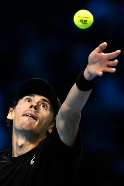Australia's Alex De Minaur serves against USA's Taylor Fritz at the ATP Finals tennis tournament in Turin on November 13, 2025. (Photo by Marco BERTORELLO / AFP)