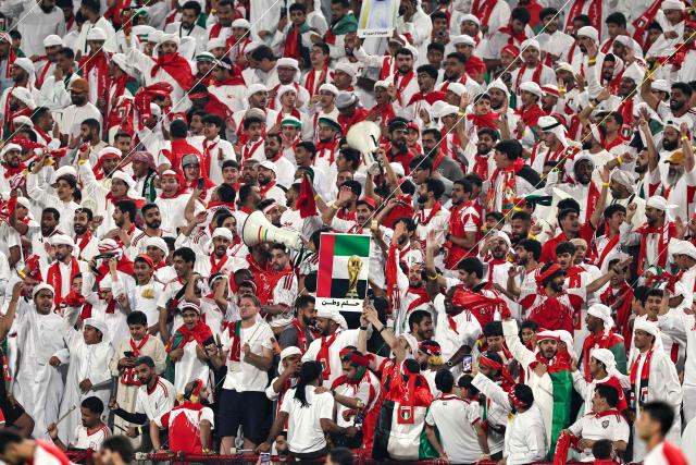 UAE fans cheer ahead of the FIFA World Cup 2026 Asian qualifier football match between the United Arab Emirates and Iraq at the Mohammed bin Zayed Stadium in Abu Dhabi on November 13, 2025. (Photo by Fadel SENNA / AFP)