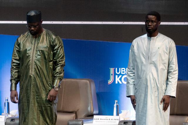 (FILES) Senegalese Prime Minister Ousmane Sonko (L) and Senegalese President Bassirou Diomaye Faye (R) attend the opening of the official ceremony of the presentation of the economic and social recovery plan by the head of government at the Grand Theatre in Dakar on August 1, 2025. Senegal's president and prime minister quarrelled on Wednesday over the dismissal of a key ally of the latter, the latest public signs of fracture at the summit of Senegalese politics.
The west African country is in the unusual position of having a president, Bassirou Dioumaye Faye, who owes his election in large part to his premier and firebrand former mentor, Ousmane Sonko.
Both swept to power on a promise of radical change in March 2024, with Sonko naming Faye as his movement's presidential candidate after being barred from running himself by the courts. (Photo by SEYLLOU / AFP)