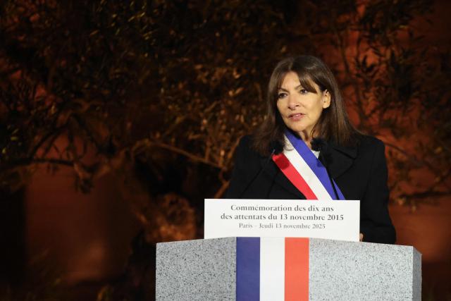 Paris' mayor Anne Hidalgo delivers a speech during a ceremony marking a decade since the terror attacks of November 13, 2015 in which 130 civilians were killed, at the "Jardin du 13 novembre 2015" in Paris on November 13, 2025. (Photo by Ludovic MARIN / POOL / AFP)
