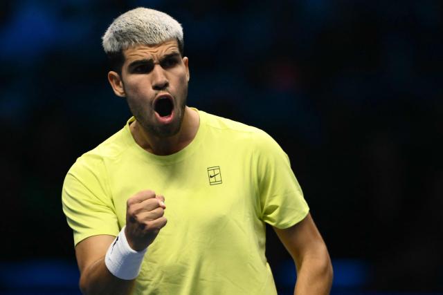 Spain's Carlos Alcaraz celebrates a point during his match against Italy's Lorenzo Musetti at the ATP Finals tennis tournament in Turin on November 13, 2025. (Photo by Marco BERTORELLO / AFP)