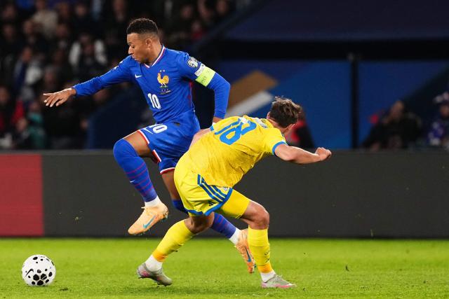 France's forward #10 Kylian Mbappe (L) fights for the ball with Ukraine's midfielder #18 Yehor Yarmolyuk during the 2026 World Cup qualifiers Europe zone group D football match between France and Ukraine at the Parc des Princes stadium in Paris, on November 13, 2025. (Photo by Dimitar DILKOFF / AFP)