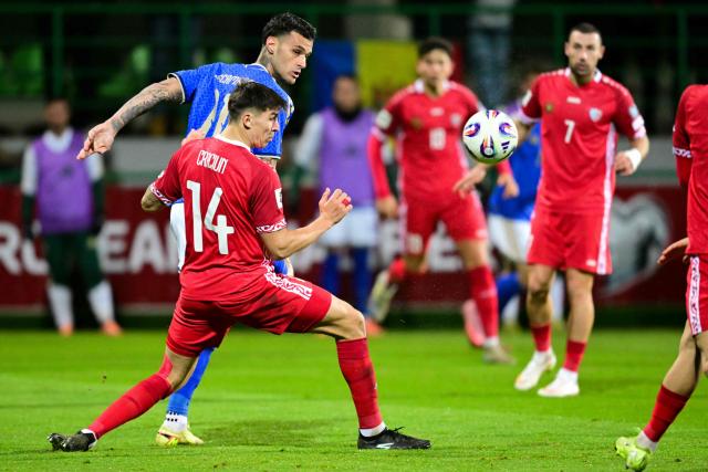 Moldova's defender #14 Artur Craciun (L) and Italy's forward #11 Gianluca Scamacca fight for the ball during the 2026 World Cup qualifiers Europe zone group I football match between Moldova and Italy at the Zimbru Stadium in Chisinau, on November 13, 2025. (Photo by Daniel MIHAILESCU / AFP)
