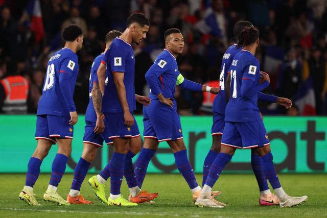 France's forward #10 Kylian Mbappe (C) celebrates after scoring his team third goal and the 400 goal of his career during the 2026 World Cup qualifiers Europe zone group D football match between France and Ukraine at the Parc des Princes stadium in Paris, on November 13, 2025. (Photo by FRANCK FIFE / AFP)