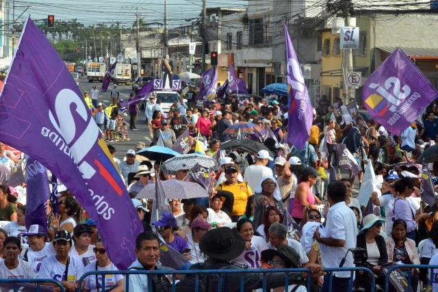 People gather ahead of the closing campaign ceremony in favor of the referendum on foreign military bases in Machala, Ecuador on November 13, 2025. (Photo by Luis SUAREZ / AFP)