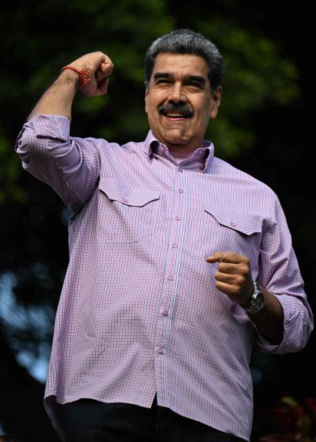 Venezuela's President Nicolas Maduro gestures during a demonstration on Youth Day in Caracas on November 13, 2025. (Photo by Juan BARRETO / AFP)