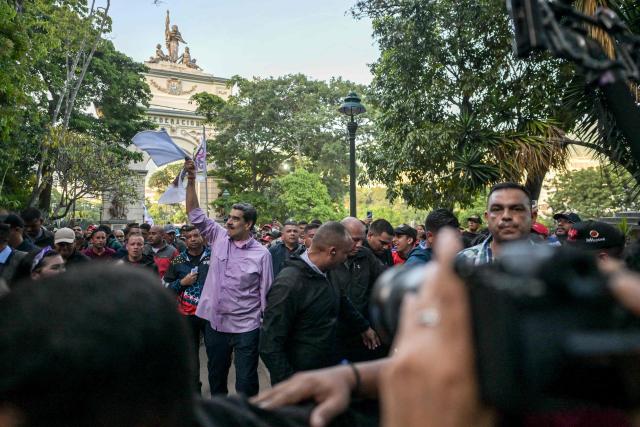 Venezuela's President Nicolas Maduro waves to supporters during a demonstration on Youth Day in Caracas on November 13, 2025. (Photo by Juan BARRETO / AFP)