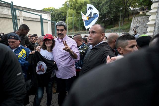 Venezuela's President Nicolas Maduro poses for a photo with a supporters during a demonstration on Youth Day in Caracas on November 13, 2025. (Photo by Juan BARRETO / AFP)
