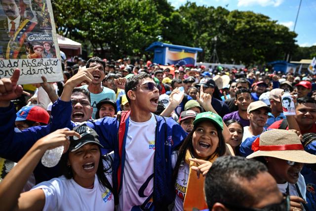 People take part in a demonstration on Youth Day in Caracas on November 13, 2025. (Photo by Juan BARRETO / AFP)