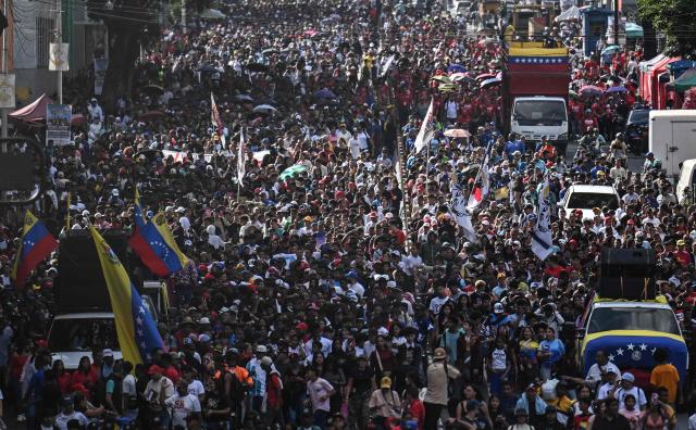 People take part in a demonstration on Youth Day in Caracas on November 13, 2025. (Photo by Juan BARRETO / AFP)