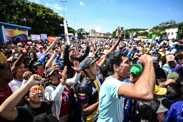 People take part in a demonstration on Youth Day in Caracas on November 13, 2025. (Photo by Juan BARRETO / AFP)